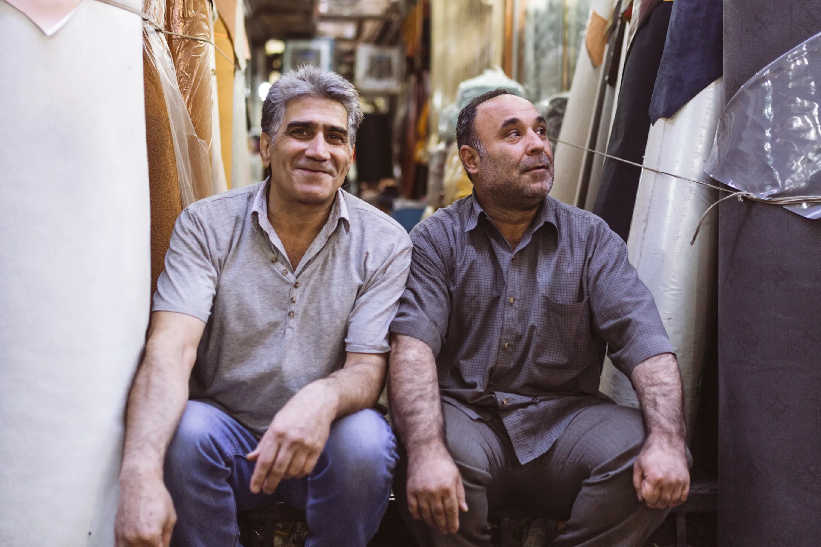 Candid photo of two Persian people at a Tehran Bazaar